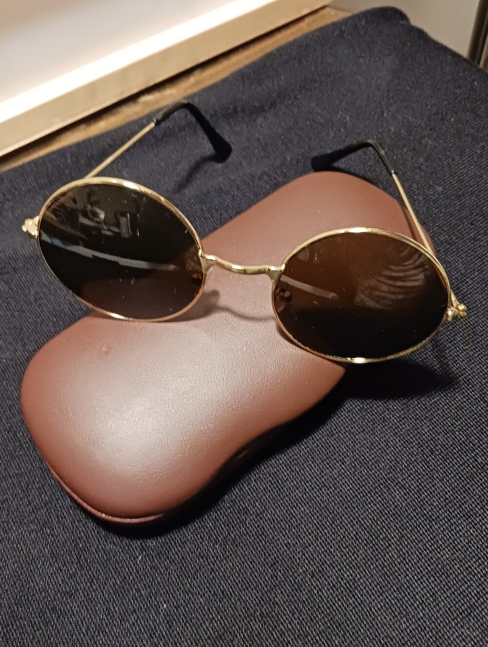 Gold Round Frame Sunglasses with Dark Glass Lenses Round Shaped.